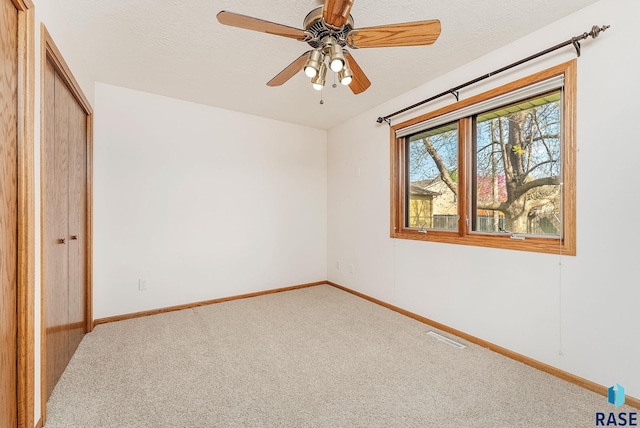 110 W Apple St, Tea, SD 57064 - unfurnished bedroom featuring carpet flooring, a closet, baseboards, and a textured ceiling