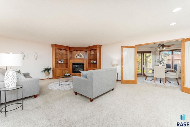 110 W Apple St, Tea, SD 57064 - living room featuring light colored carpet, baseboards, ceiling fan, recessed lighting, and a glass covered fireplace