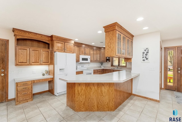110 W Apple St, Tea, SD 57064 - kitchen featuring white appliances, a peninsula, a sink, glass insert cabinets, and light countertops