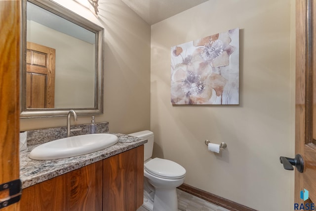 904 W Chicory Ln, Sioux Falls, SD 57108 - half bath featuring toilet, baseboards, and vanity