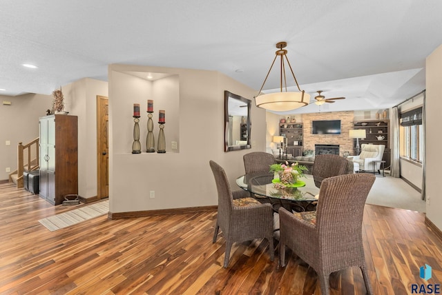 904 W Chicory Ln, Sioux Falls, SD 57108 - dining room with baseboards, wood finished floors, ceiling fan, a large fireplace, and recessed lighting