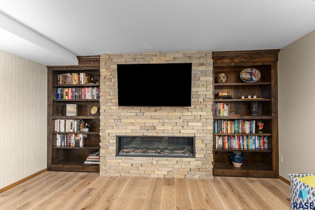 904 W Chicory Ln, Sioux Falls, SD 57108 - living area featuring wood finished floors, baseboards, a fireplace, and built in shelves