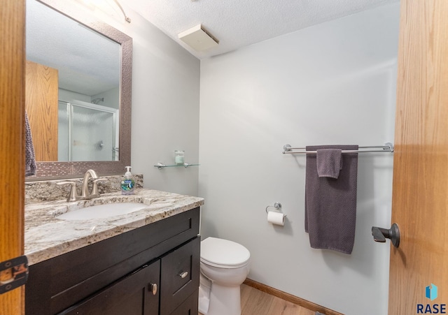 904 W Chicory Ln, Sioux Falls, SD 57108 - full bath with a shower stall, toilet, wood finished floors, vanity, and baseboards