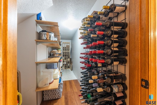 904 W Chicory Ln, Sioux Falls, SD 57108 - wine area with a textured ceiling, wood finished floors, and lofted ceiling