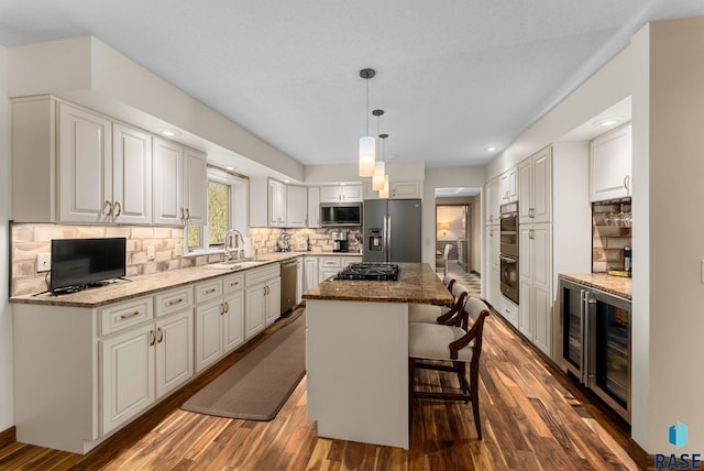 904 W Chicory Ln, Sioux Falls, SD 57108 - kitchen featuring appliances with stainless steel finishes, a center island, a sink, dark wood-style floors, and recessed lighting