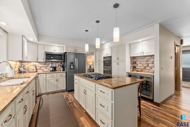 904 W Chicory Ln, Sioux Falls, SD 57108 - kitchen with appliances with stainless steel finishes, a sink, wood finished floors, tasteful backsplash, and recessed lighting