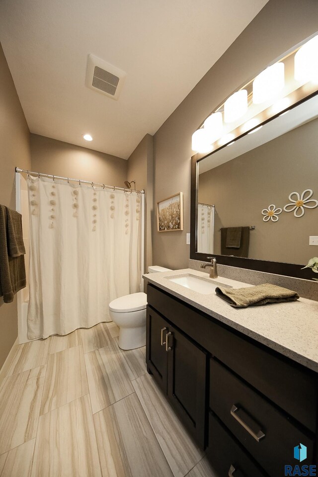 403 Granite Ave, Tea, SD 57064 - bathroom with toilet, vanity, curtained shower, and recessed lighting