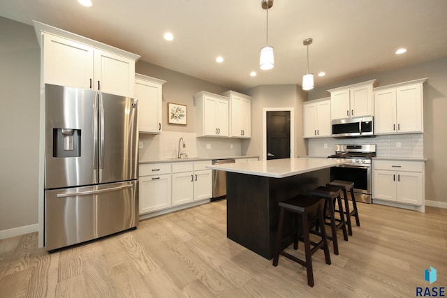 403 Granite Ave, Tea, SD 57064 - kitchen with stainless steel appliances, a sink, backsplash, white cabinets, and recessed lighting