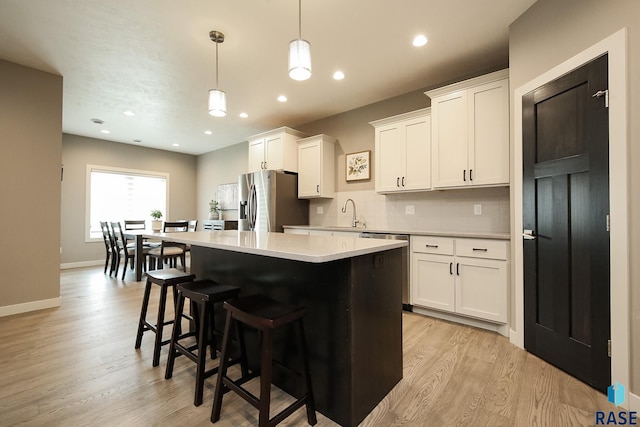 403 Granite Ave, Tea, SD 57064 - kitchen with stainless steel appliances, light wood-style floors, a kitchen island, light countertops, and recessed lighting