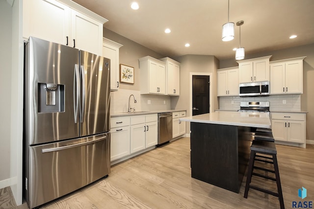 403 Granite Ave, Tea, SD 57064 - kitchen featuring appliances with stainless steel finishes, a sink, decorative backsplash, light countertops, and white cabinetry
