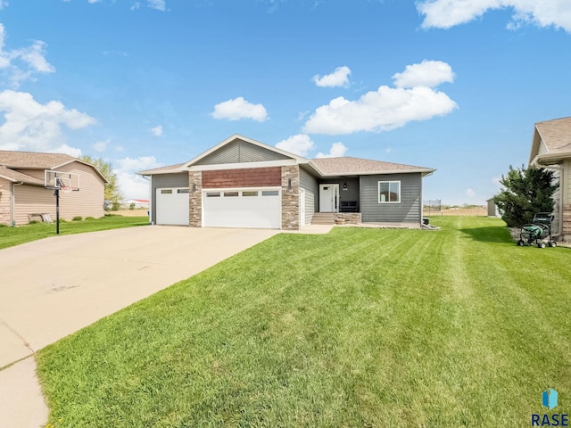 615 Marsha Cir, Tea, SD 57064 - view of front of house featuring stone siding, a front lawn, driveway, and an attached garage