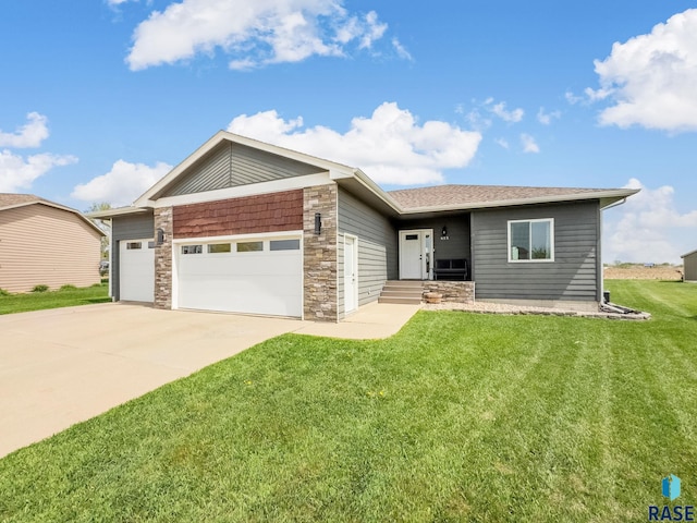 615 Marsha Cir, Tea, SD 57064 - view of front of property featuring a garage, stone siding, a front lawn, and concrete driveway