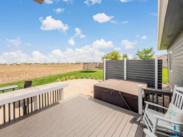 615 Marsha Cir, Tea, SD 57064 - deck with a hot tub, a trampoline, a rural view, agricultural plots, and a lawn