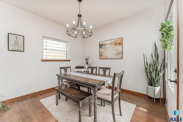 615 Marsha Cir, Tea, SD 57064 - dining space with a chandelier, wood finished floors, and baseboards