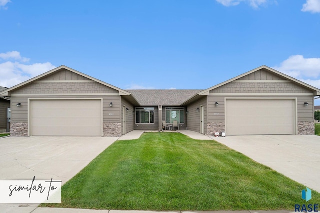 view of front of home featuring stone siding, concrete driveway, a garage, and a front yard