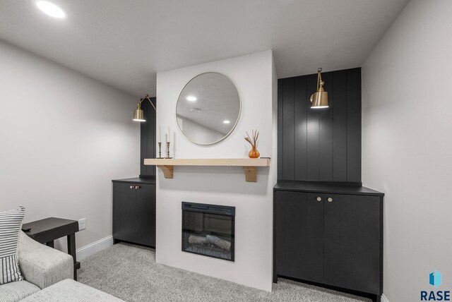 carpeted living room featuring baseboards and recessed lighting