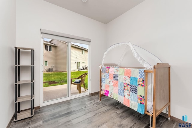 bedroom with wood finished floors and baseboards