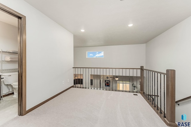 hall with an upstairs landing, carpet flooring, recessed lighting, and baseboards
