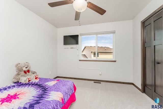 carpeted bedroom with baseboards and a ceiling fan