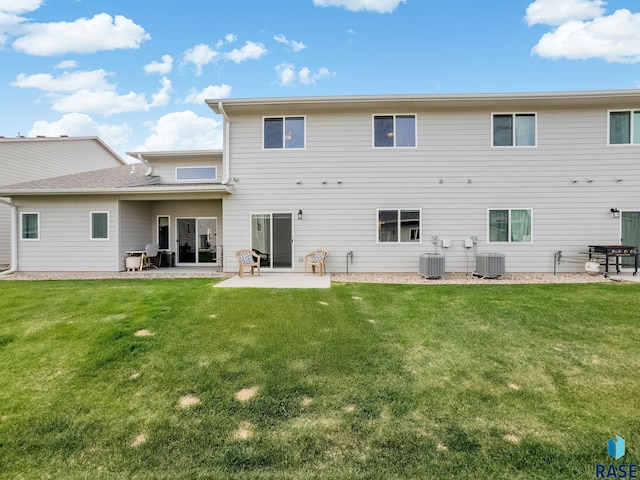 back of property with a patio, central AC, and a yard