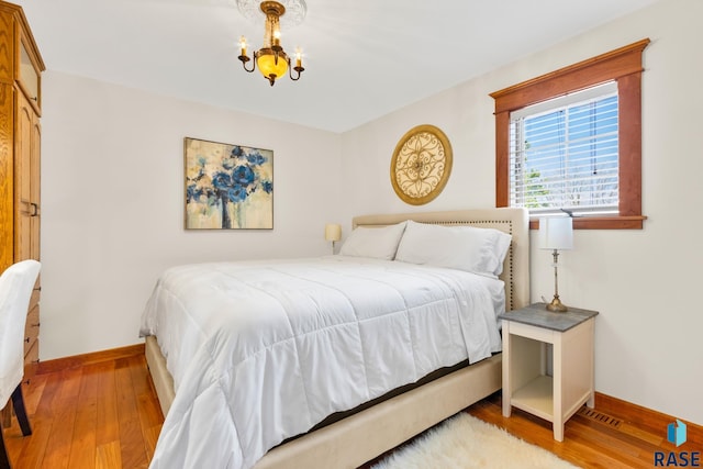 28262 472nd Ave, Worthing, SD 57077 - bedroom featuring a chandelier, baseboards, and wood finished floors
