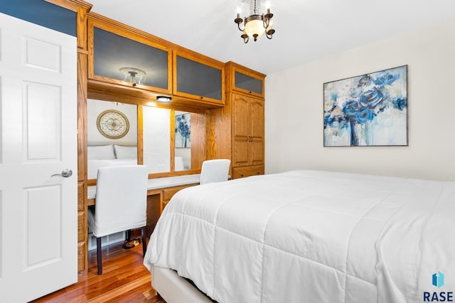 28262 472nd Ave, Worthing, SD 57077 - bedroom with wood finished floors and a chandelier