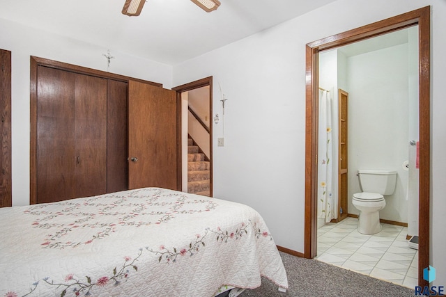 bedroom with ensuite bathroom, baseboards, ceiling fan, light colored carpet, and light tile patterned floors