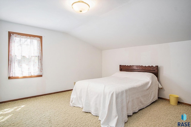 bedroom featuring vaulted ceiling, carpet floors, and baseboards