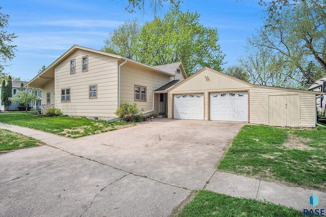 view of front of property with an outbuilding, a front yard, and a garage