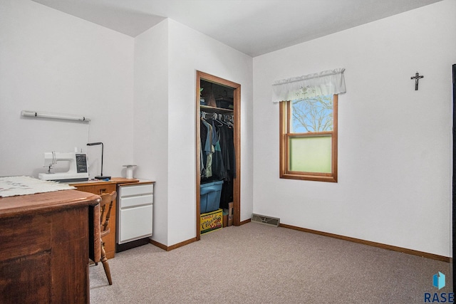 bedroom with light colored carpet, baseboards, and a closet