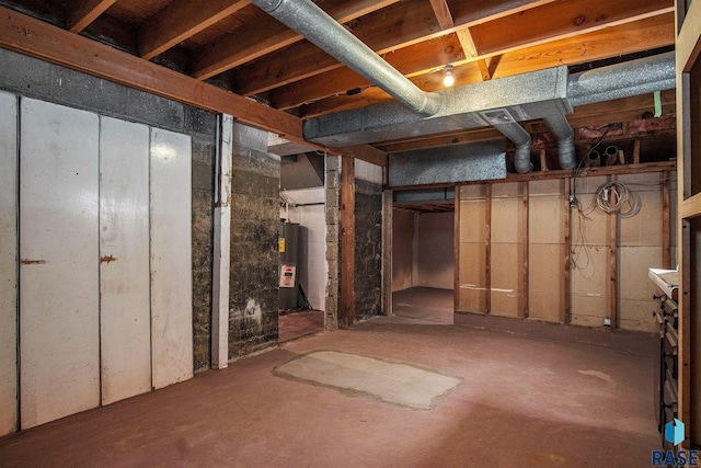 unfinished below grade area with electric water heater
