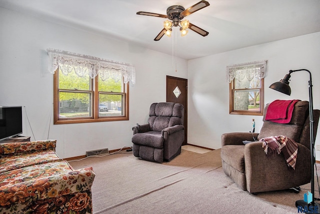 living area with carpet floors and ceiling fan