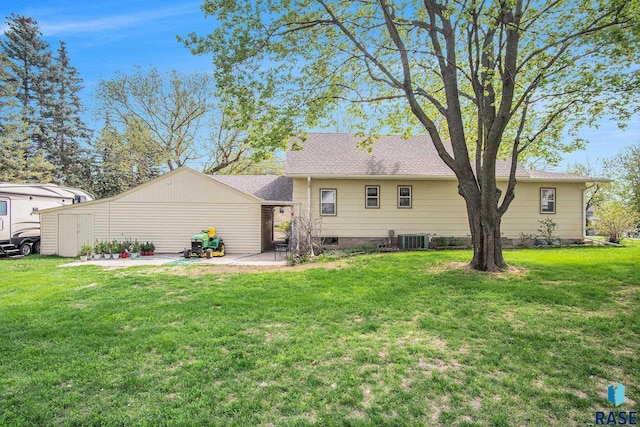 rear view of house featuring central air condition unit, a patio area, and a lawn