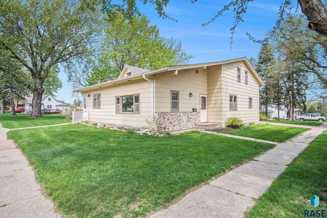 view of front of house featuring a front yard and stone siding