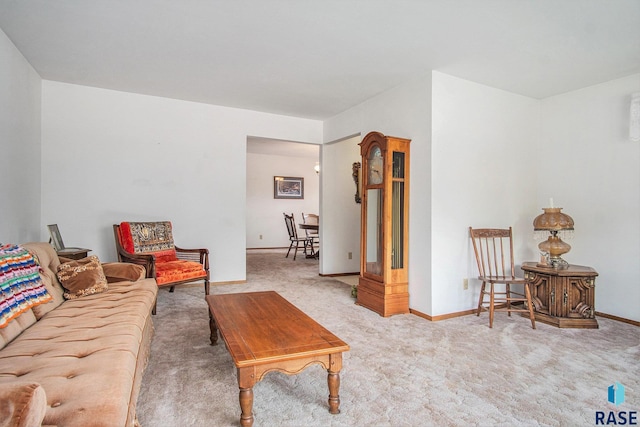 carpeted living area with baseboards