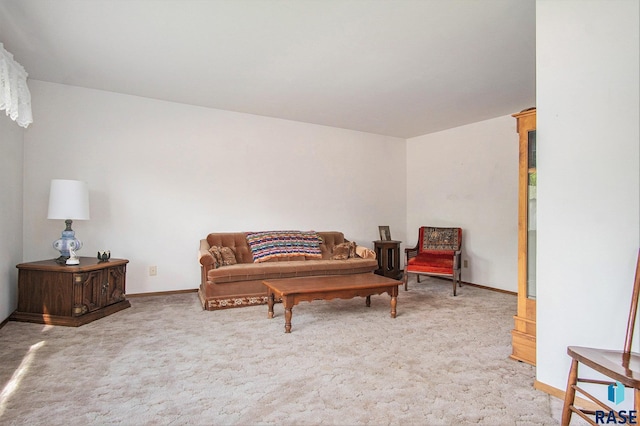 sitting room featuring carpet floors and baseboards