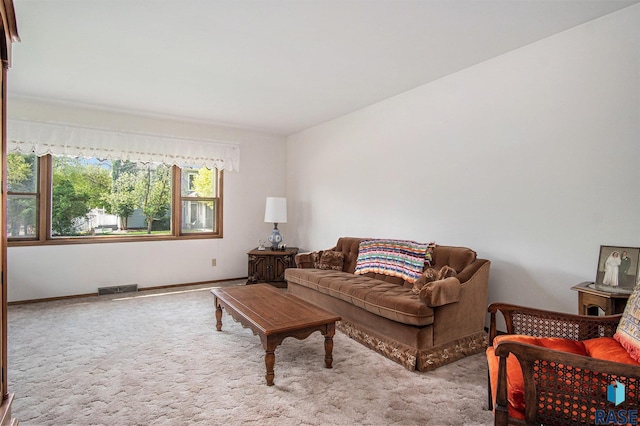 carpeted living area with baseboards