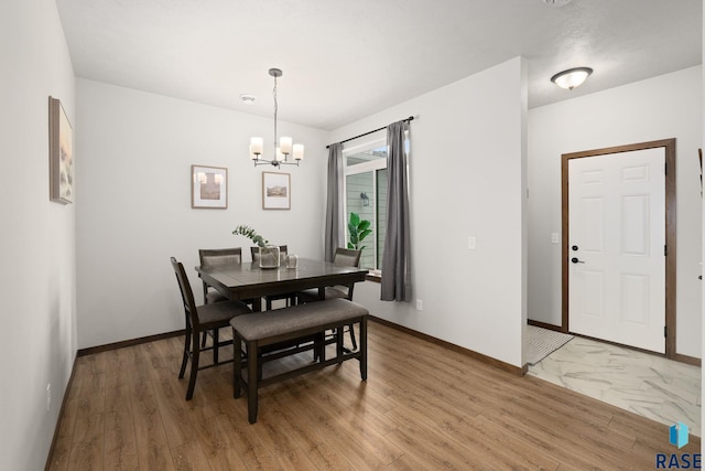 8162 E Tencate Pl, Sioux Falls, SD 57110 - dining room with a chandelier, baseboards, and light wood finished floors