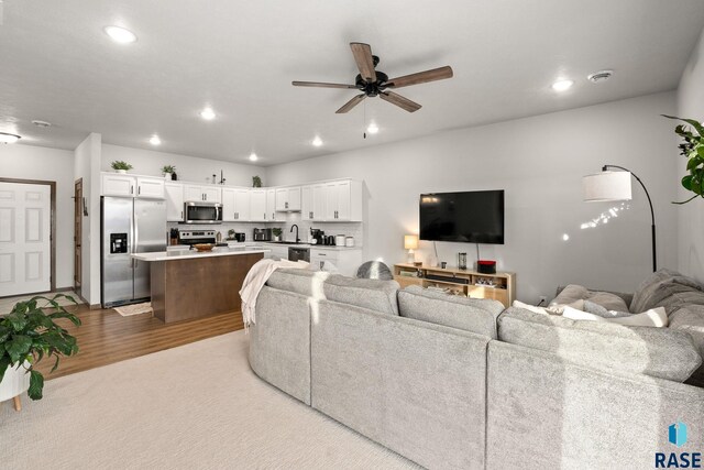 8162 E Tencate Pl, Sioux Falls, SD 57110 - living room with recessed lighting, ceiling fan, and wood finished floors