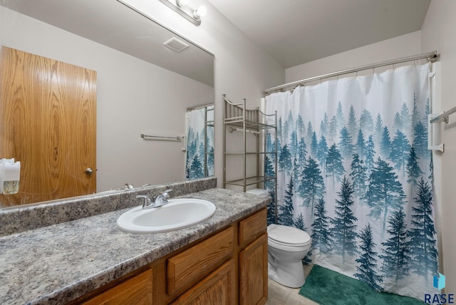 bathroom featuring vanity, toilet, tile patterned flooring, and curtained shower