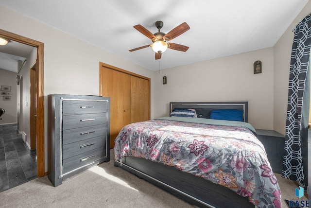carpeted bedroom featuring a closet and a ceiling fan
