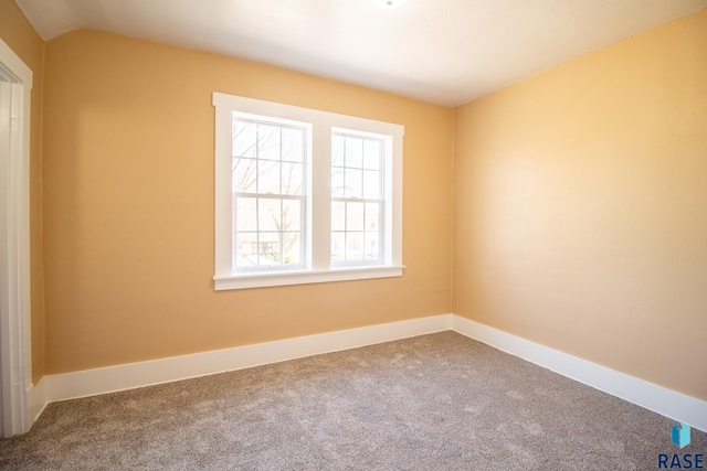 carpeted spare room with baseboards