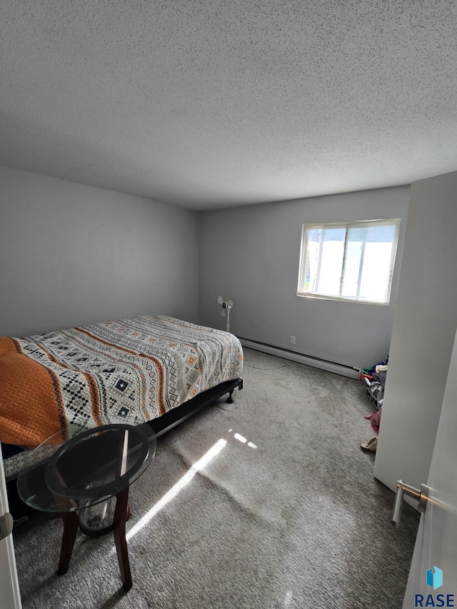 310 Jackson St, Valley Springs, SD 57068 - carpeted bedroom featuring baseboard heating and a textured ceiling