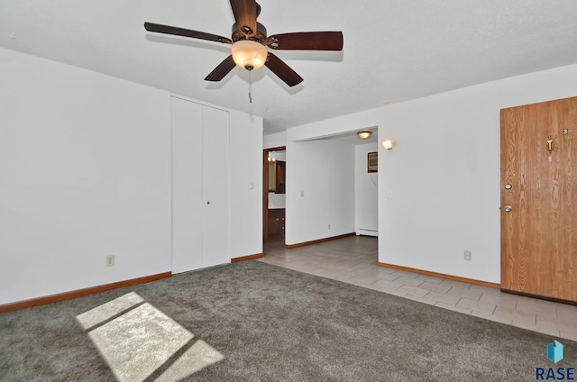 310 Jackson St, Valley Springs, SD 57068 - carpeted empty room featuring a ceiling fan, baseboards, and tile patterned flooring