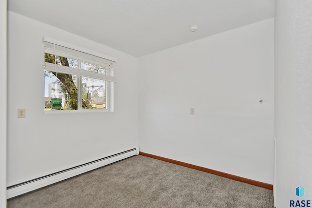 310 Jackson St, Valley Springs, SD 57068 - carpeted empty room with a baseboard heating unit and baseboards