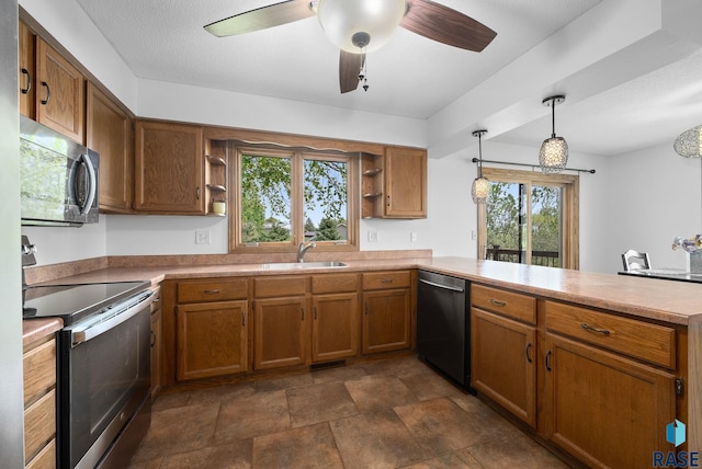 kitchen with appliances with stainless steel finishes, open shelves, a peninsula, a sink, and brown cabinetry