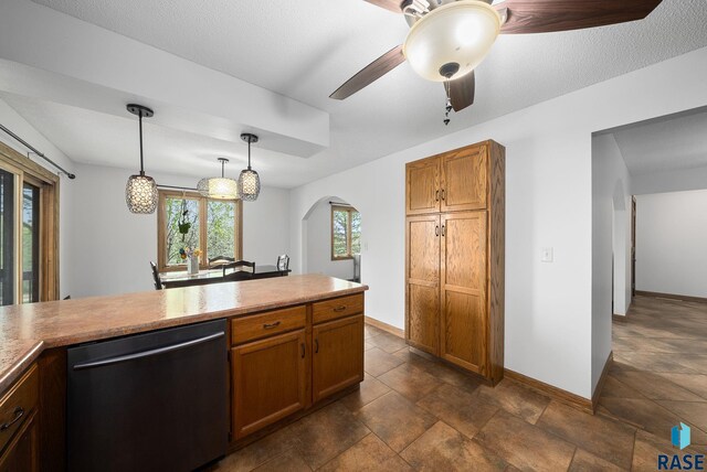 kitchen featuring dishwasher, arched walkways, a ceiling fan, baseboards, and hanging light fixtures