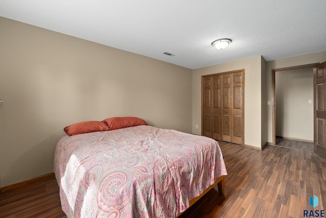 bedroom featuring wood finished floors, a closet, and baseboards
