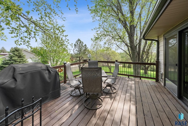 wooden deck with a grill