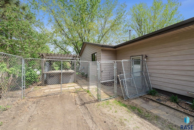 view of side of property with a gate and fence